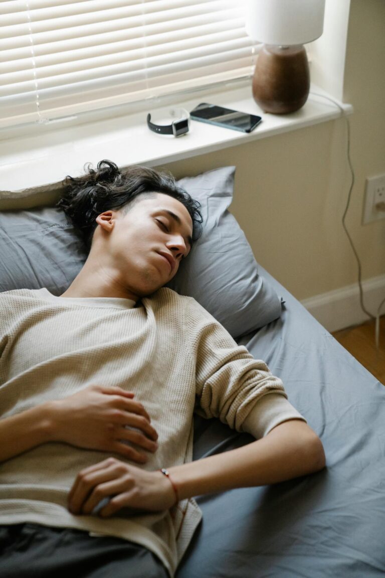 Jovem dormindo tranquilamente na cama durante a manhã